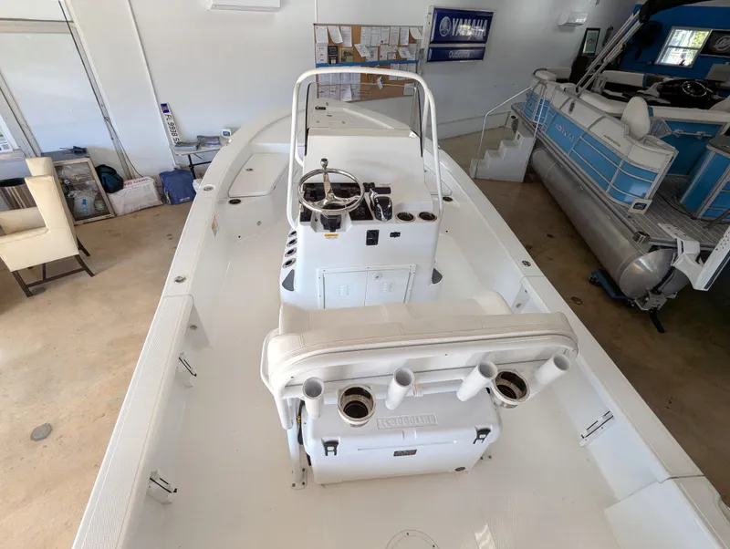 Slide: The Image of BlackJack 224 boat interior, 2025 model, featuring steering console and seating in a showroom. - 10