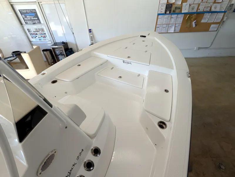 Slide: The Image of 2025 BlackJack 224 boat interior, showcasing spacious deck and storage compartments. - 12