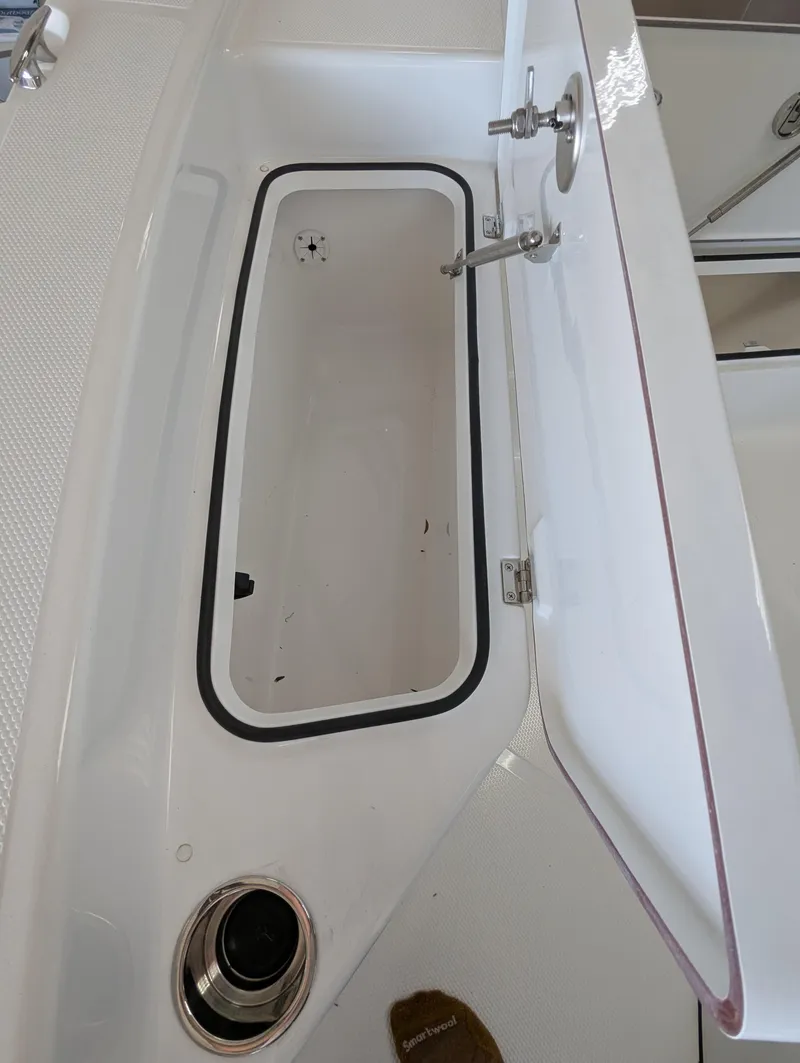 Slide: The Image of Open storage compartment on a 2025 BlackJack 224 boat. - 19