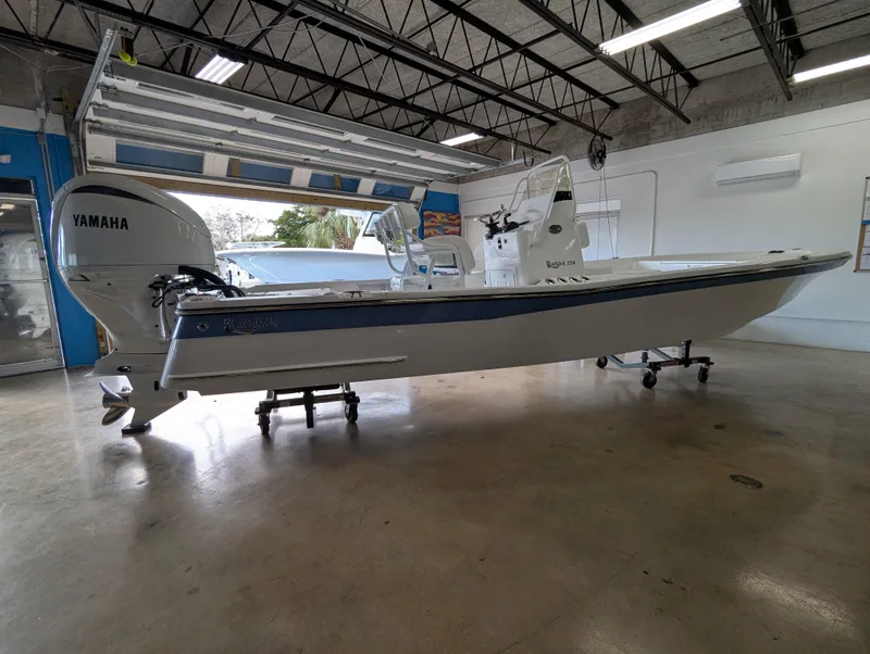 Slide: The Image of 2025 BlackJack 224 boat with Yamaha engine in showroom. - 2