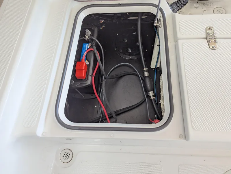 Slide: The Image of Open hatch of BlackJack 224 boat showing battery and wiring, 2025 model. - 22