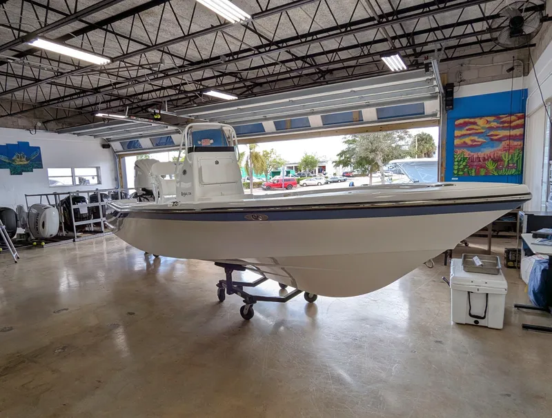 Slide: The Image of 2025 BlackJack 224 boat in a spacious indoor showroom. - 3