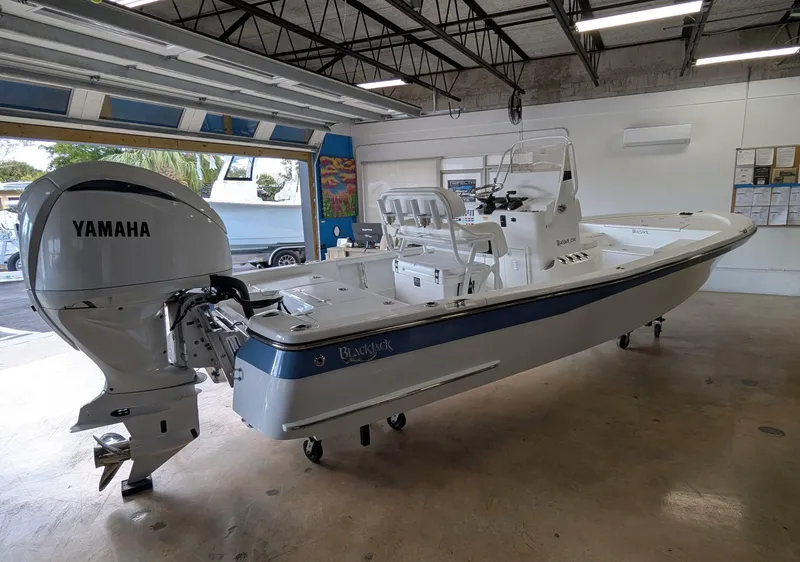 Slide: The Image of 2025 BlackJack 224 boat with Yamaha engine in a showroom. - 4