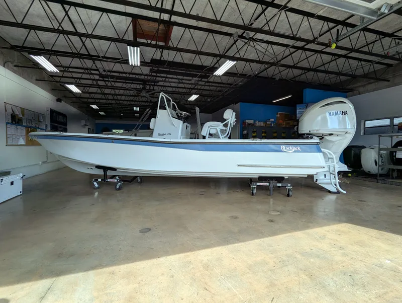 Slide: The Image of 2025 BlackJack 224 boat in showroom, featuring Yamaha outboard motor. - 6