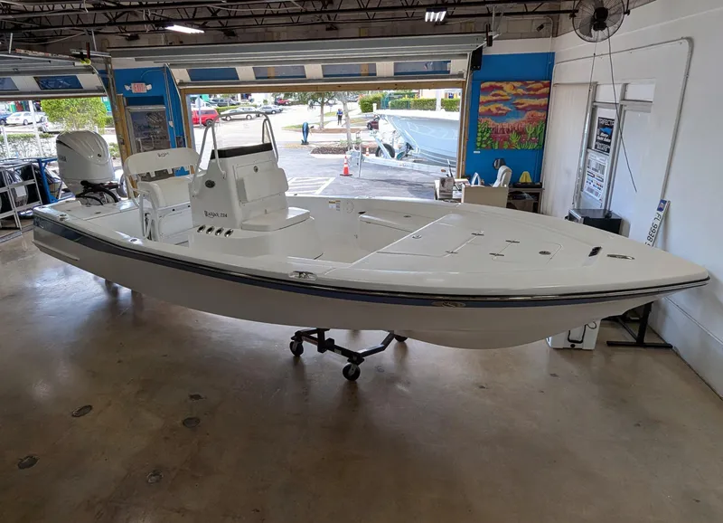 Slide: The Image of 2025 BlackJack 224 boat displayed in a showroom, showcasing sleek design and modern features. - 7