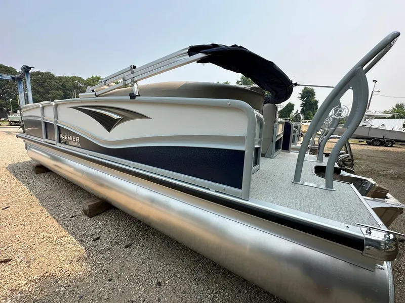Slide: The Image of 2023 Premier 250 Solaris RF pontoon boat, side view, parked on gravel. - 5