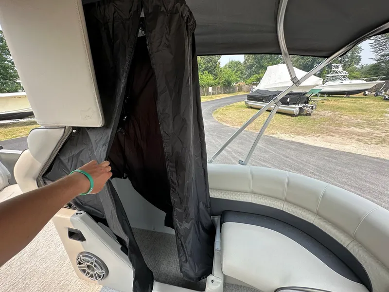 Slide: The Image of 2023 Premier 250 Solaris RL boat interior with privacy curtain and seating. - 12