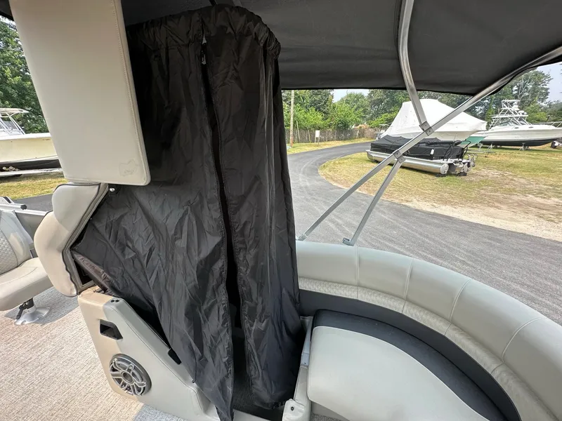 Slide: The Image of 2023 Premier 250 Solaris RL boat interior with privacy curtain and seating. - 13