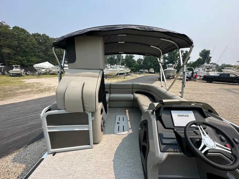 Slide: The Image of 2023 Premier 250 Solaris RL pontoon boat with spacious seating and modern helm. - 14