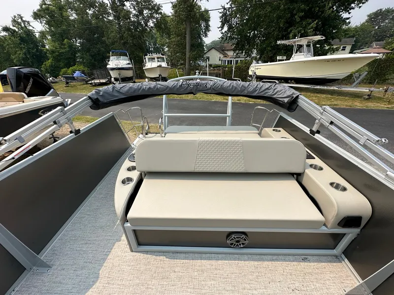 Slide: The Image of 2023 Premier 250 Solaris RL pontoon boat with beige seating and sleek design. - 16
