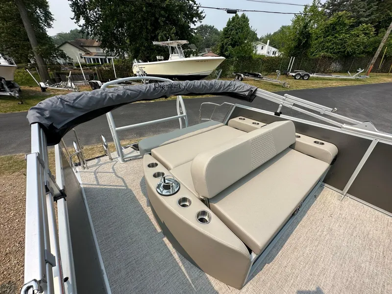 Slide: The Image of 2023 Premier 250 Solaris RL pontoon boat with beige seating and cup holders. - 17
