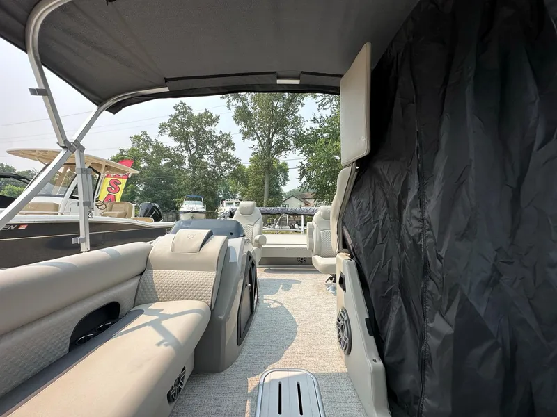 Slide: The Image of 2023 Premier 250 Solaris RL pontoon boat interior with seating and canopy. - 18