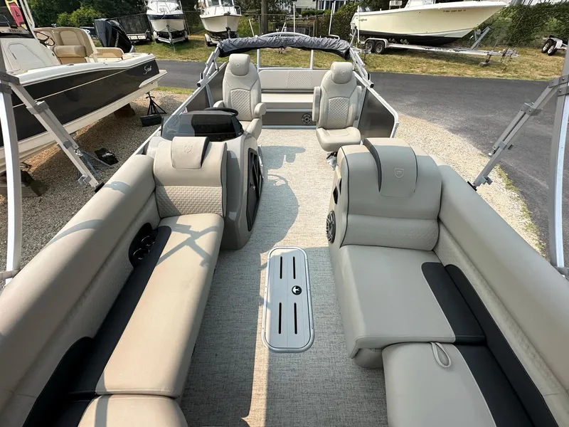 Slide: The Image of 2023 Premier 250 Solaris RL pontoon boat interior with beige seating and modern design. - 5