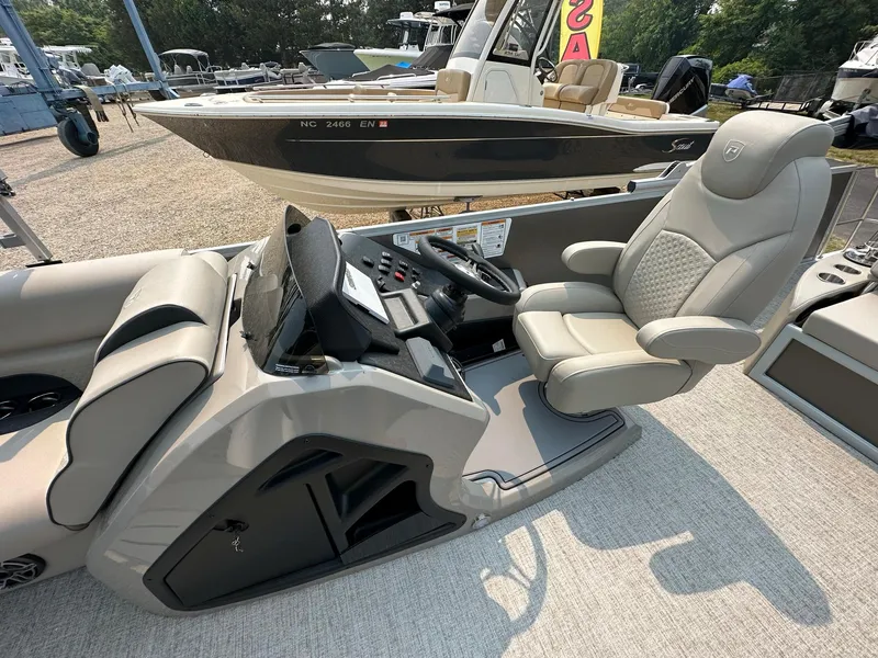 Slide: The Image of 2023 Premier 250 Solaris RL boat interior with luxurious seating and modern dashboard. - 8