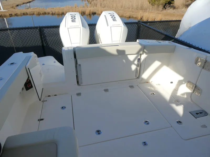 Slide: The Image of 2025 Boston Whaler 280 Vantage boat deck with dual engines, spacious seating, and storage. - 11
