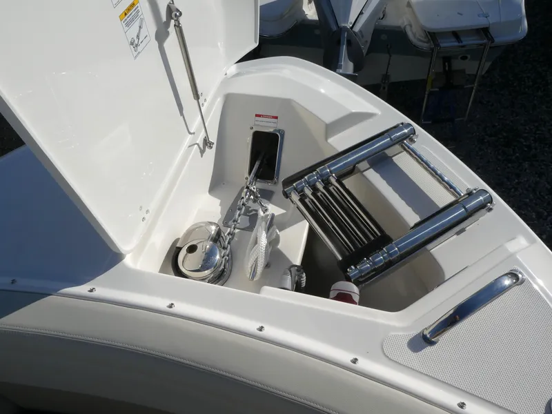 Slide: The Image of 2025 Boston Whaler 280 Vantage boat anchor storage compartment with ladder. - 15