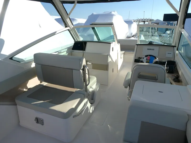 Slide: The Image of 2025 Boston Whaler 280 Vantage boat interior with seating and helm. - 5