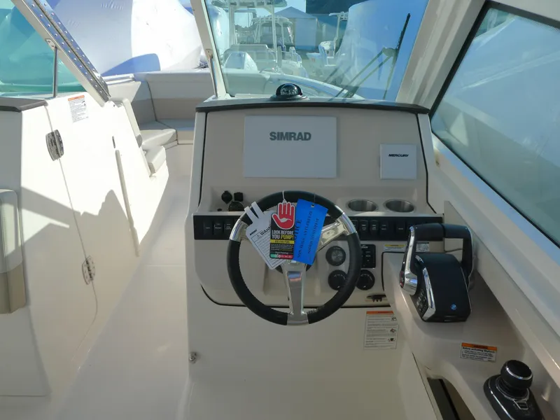 Slide: The Image of Boston Whaler 280 Vantage 2025 boat cockpit with steering wheel and control panel. - 6