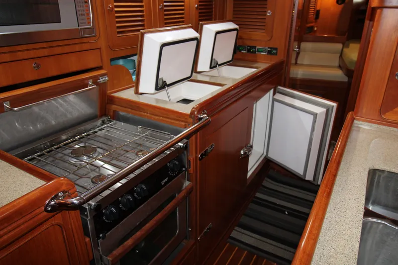Slide: The Image of Galley kitchen in 2006 Hylas 49 Center Cockpit yacht with stove and storage. - 12