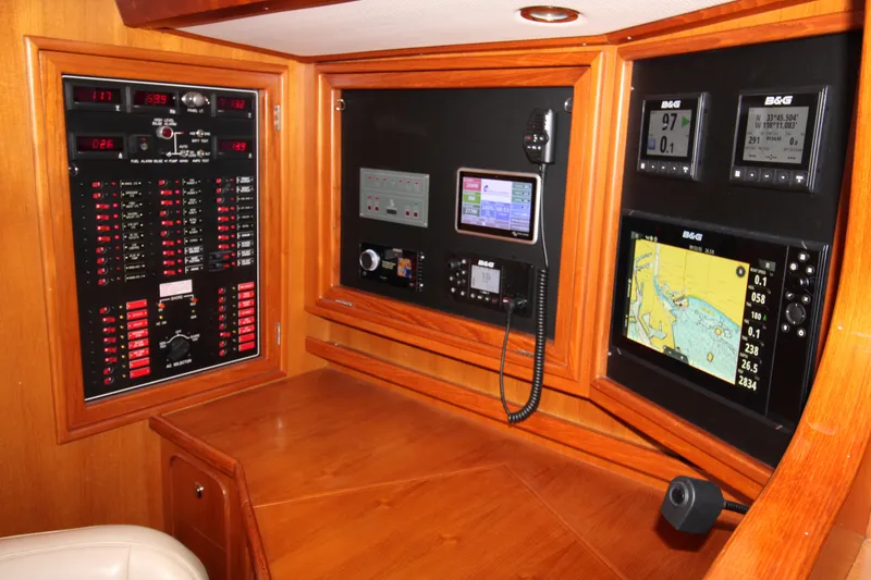 Slide: The Image of Navigation station of 2006 Hylas 49 Center Cockpit with control panels and electronic displays. - 15