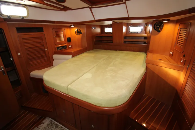 Slide: The Image of Luxurious 2006 Hylas 49 Center Cockpit interior with spacious wooden cabin and comfortable bed. - 17