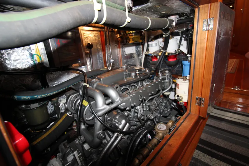 Slide: The Image of Engine room of a 2006 Hylas 49 Center Cockpit sailboat, showcasing mechanical components. - 19