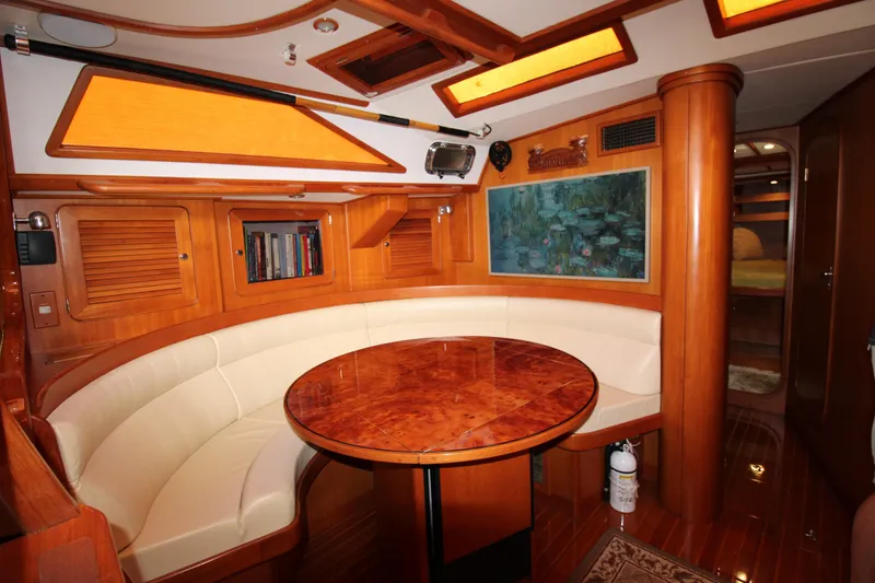 Slide: The Image of Luxurious interior of 2006 Hylas 49 Center Cockpit yacht with elegant wood finish and seating area. - 2