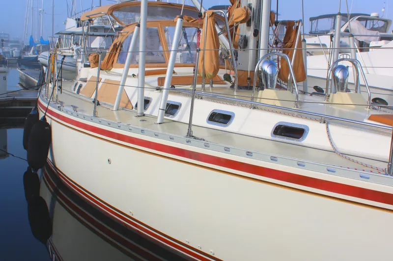 Slide: The Image of 2006 Hylas 49 Center Cockpit yacht docked in marina, featuring sleek design and vibrant accents. - 24