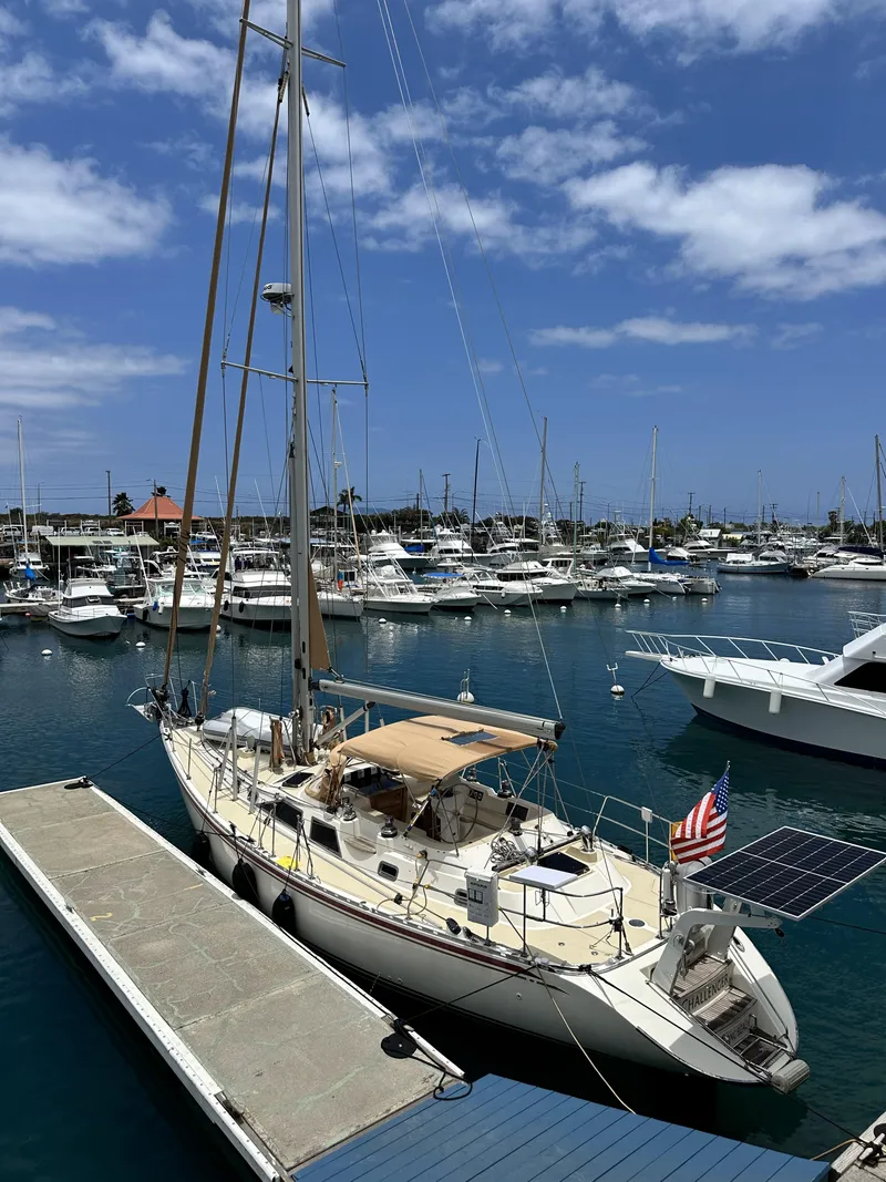 Slide: The Image of 2006 Hylas 49 Center Cockpit yacht docked in a marina under a blue sky. - 5