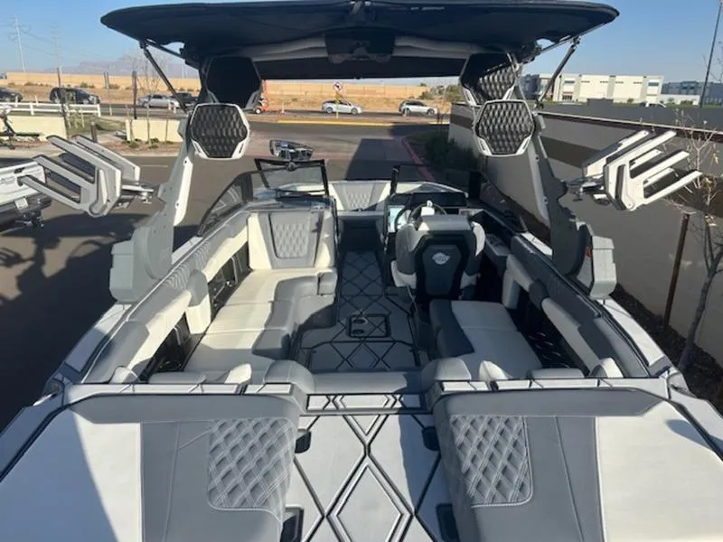 Slide: The Image of 2025 Malibu M230 boat interior with modern seating and advanced audio system. - 10