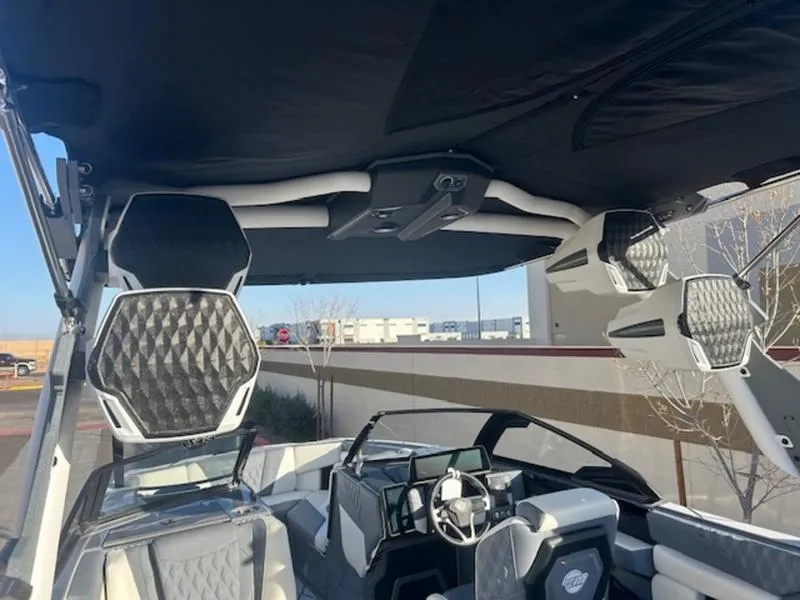 Slide: The Image of 2025 Malibu M230 boat interior with advanced sound system and sleek design. - 12