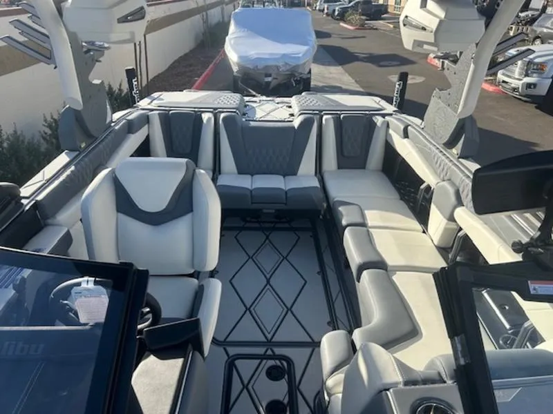 Slide: The Image of 2025 Malibu M230 boat interior with luxurious seating and modern design. - 15