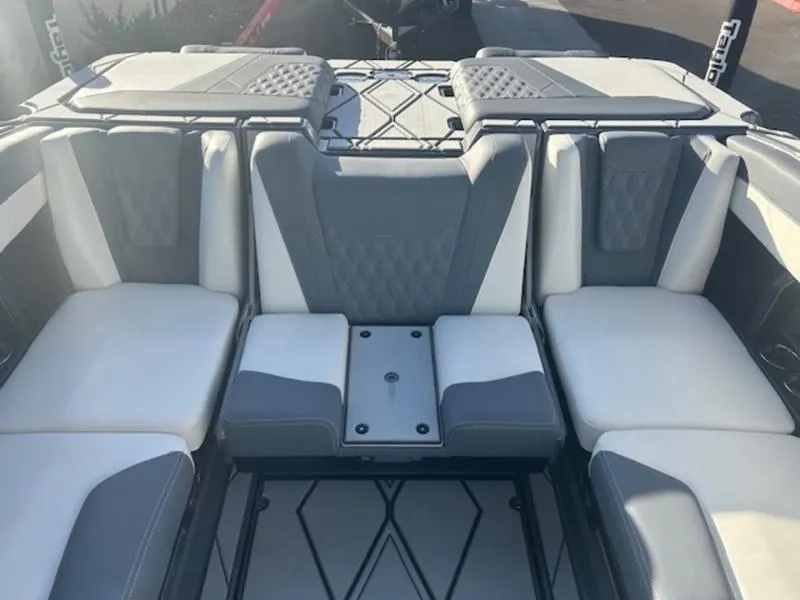 Slide: The Image of 2025 Malibu M230 boat interior with gray and white seating. - 17