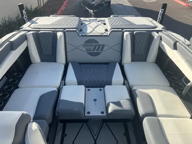 Slide: The Image of 2025 Malibu M230 boat interior with gray and white seating, modern design. - 19