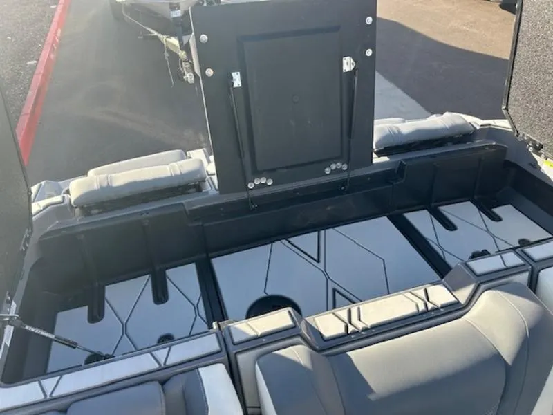 Slide: The Image of 2025 Malibu M230 boat interior with sleek seating and storage compartments. - 22