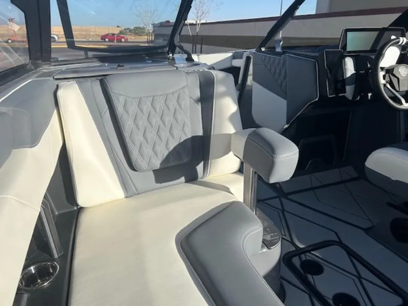 Slide: The Image of 2025 Malibu M230 boat interior with gray and white seating, modern design. - 23