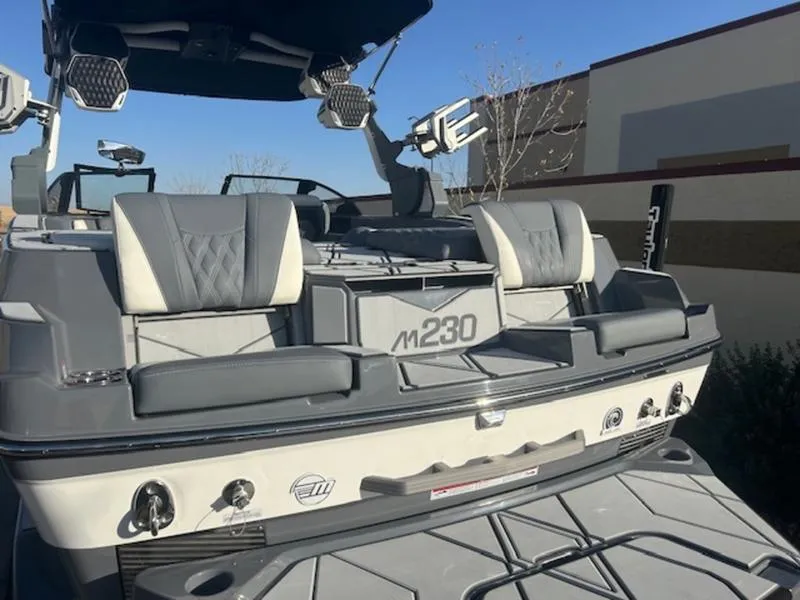 Slide: The Image of 2025 Malibu M230 boat with sleek gray seating and modern design. - 9