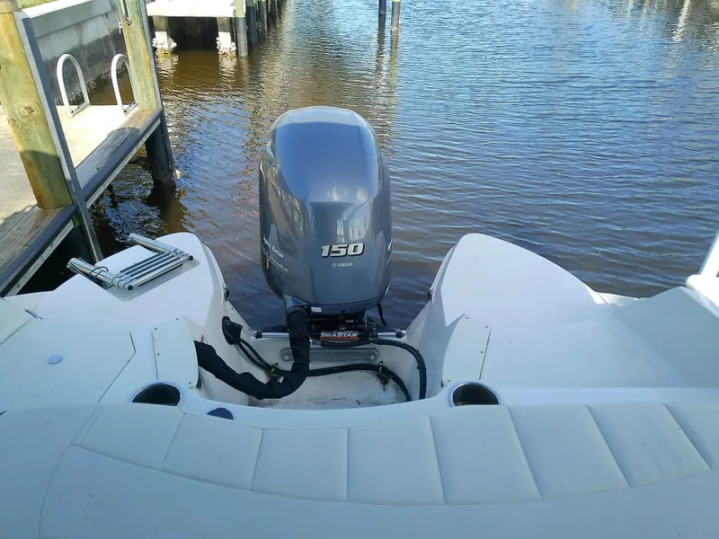 Slide: The Image of 2021 Stingray 214 LR boat with 150 HP outboard motor on calm water. - 14
