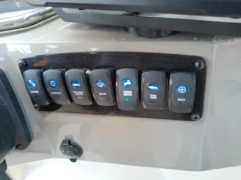 Slide: The Image of Control panel of a 2021 Stingray 214 LR boat with labeled switches. - 26
