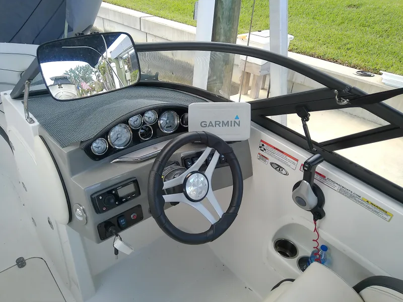 Slide: The Image of 2021 Stingray 214 LR boat dashboard with Garmin navigation system and steering wheel. - 29