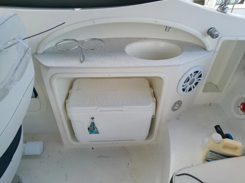 Slide: The Image of 2021 Stingray 214 LR boat interior with sink, cooler, and speaker. - 34