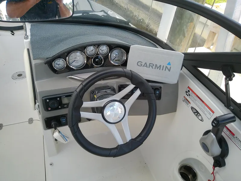 Slide: The Image of 2021 Stingray 214 LR boat dashboard with Garmin navigation system. - 43