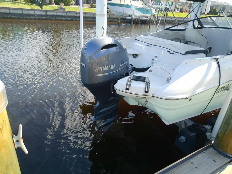 Slide: The Image of 2021 Stingray 214 LR boat with Yamaha outboard motor docked in a marina. - 6