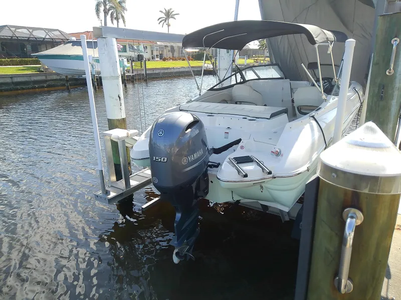 Slide: The Image of 2021 Stingray 214 LR boat with Yamaha engine docked in marina. - 8