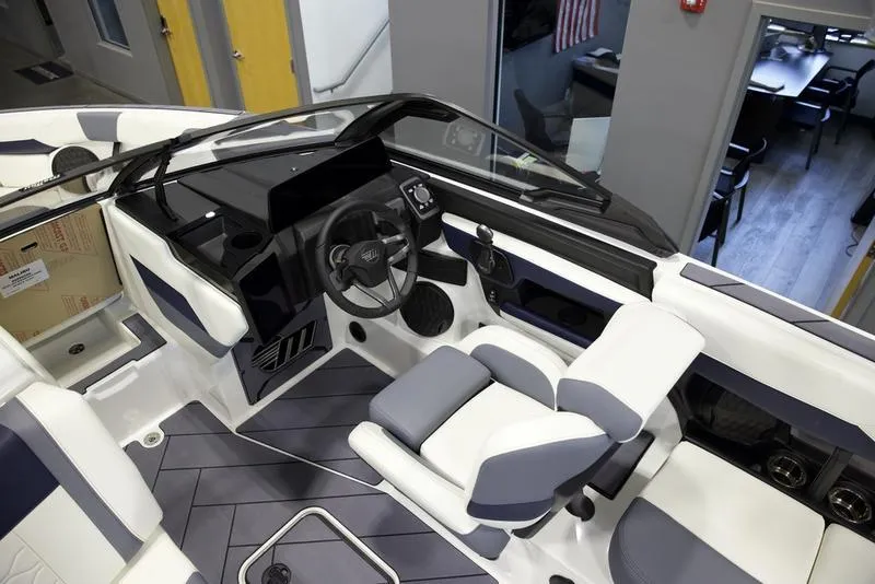 Slide: The Image of 2025 Malibu 23 LSV boat interior with modern dashboard and seating. - 12