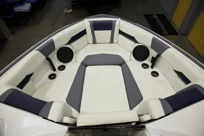 Slide: The Image of 2025 Malibu 23 LSV boat interior with white and gray seating. - 16
