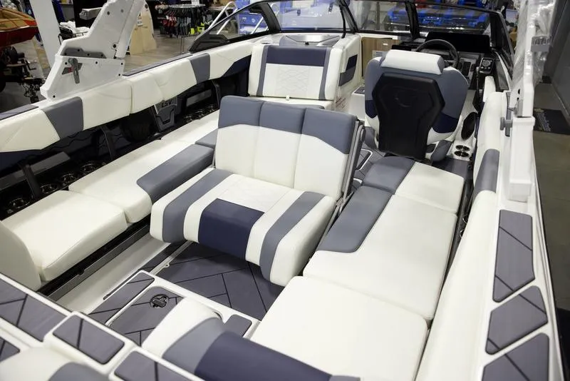 Slide: The Image of 2025 Malibu 23 LSV boat interior with modern seating and sleek design. - 19