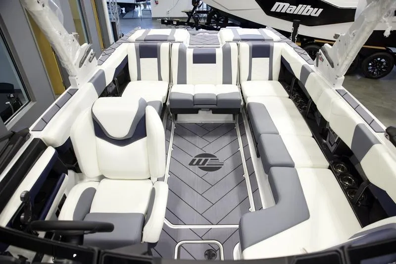 Slide: The Image of 2025 Malibu 23 LSV boat interior with white and gray seating. - 26
