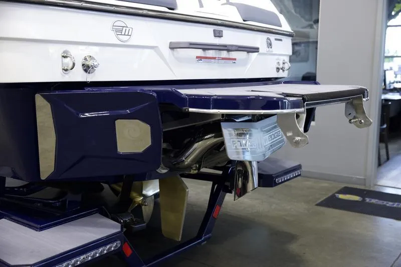 Slide: The Image of 2025 Malibu 23 LSV boat rear view with swim platform and exhaust system. - 5