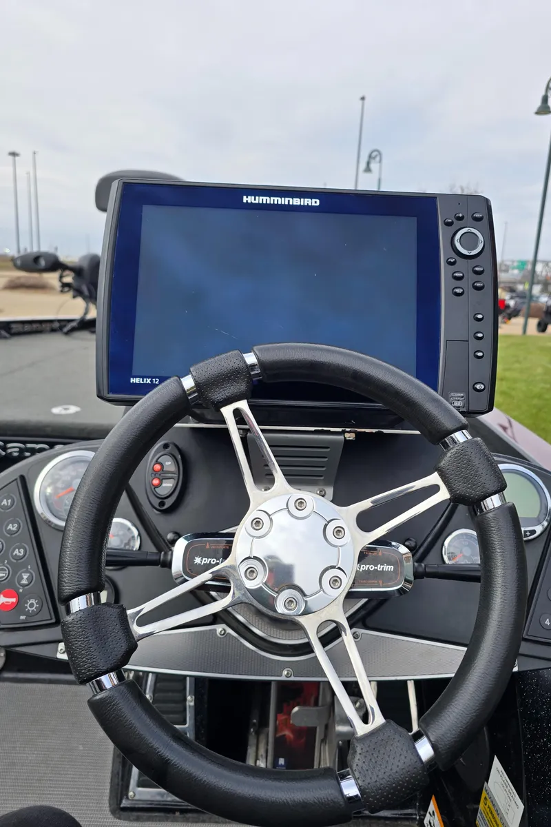 Slide: The Image of 2017 Ranger Z520C boat dashboard with steering wheel and Humminbird fishfinder. - 1